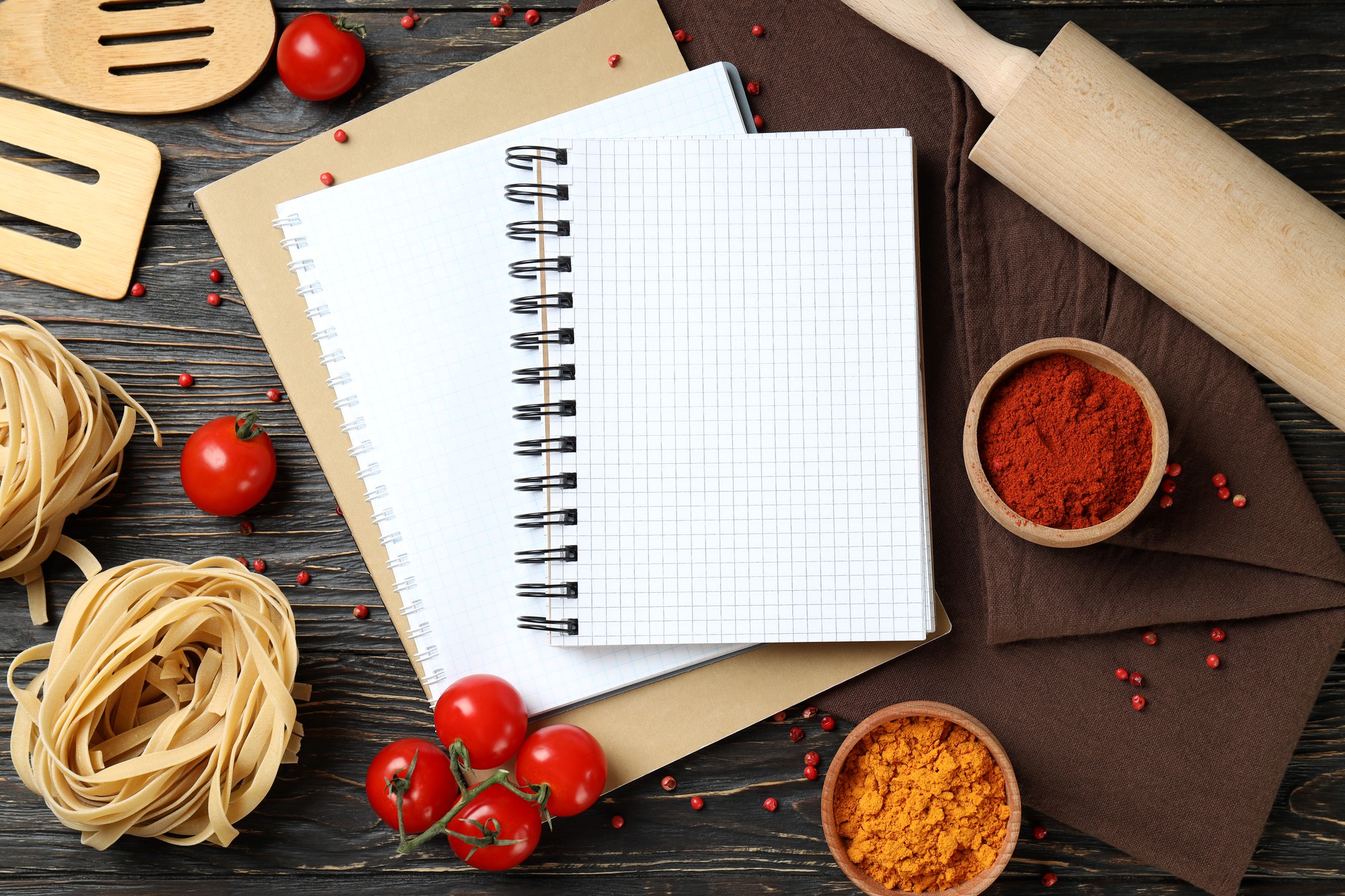 stacked notebooks and annotated recipe